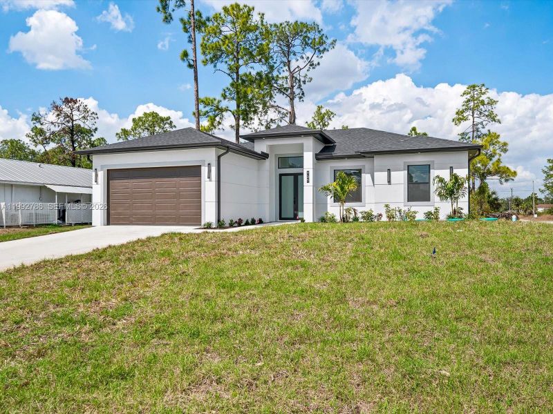 Front exterior of a new home in , Lehigh Acres, FL, highlighting curb appeal (Image 18).