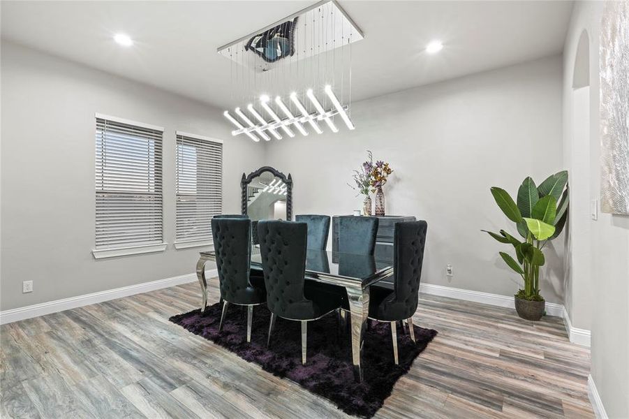 Dining area featuring light wood finished floors and recessed lighting