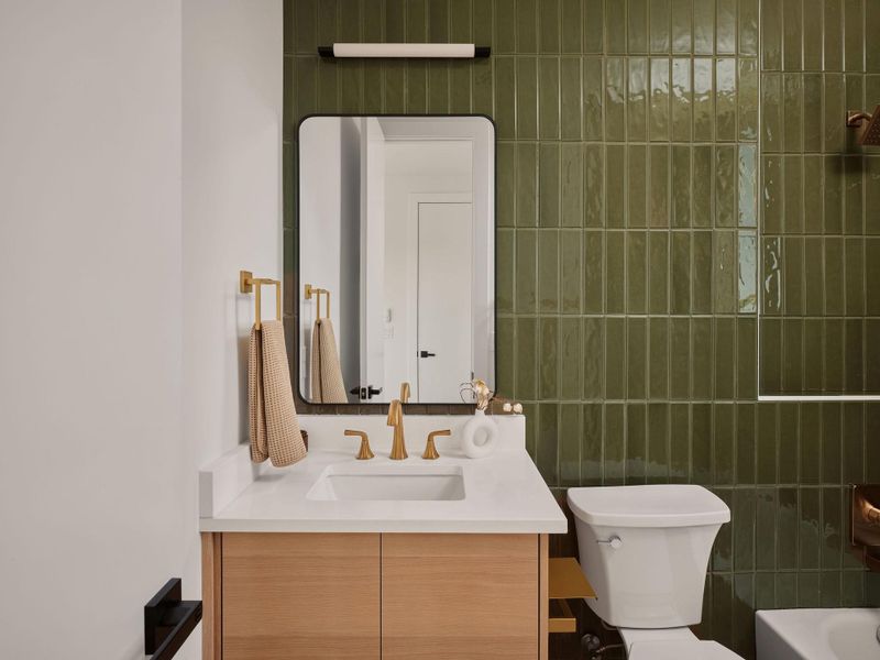 Bathroom with vanity and tile walls