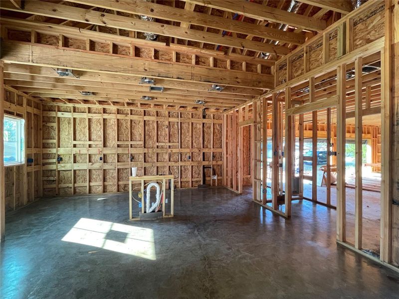 View of the kitchen with an Island. To the Right is the pantry and Laundry room area that opens to the 3 Car Garage.