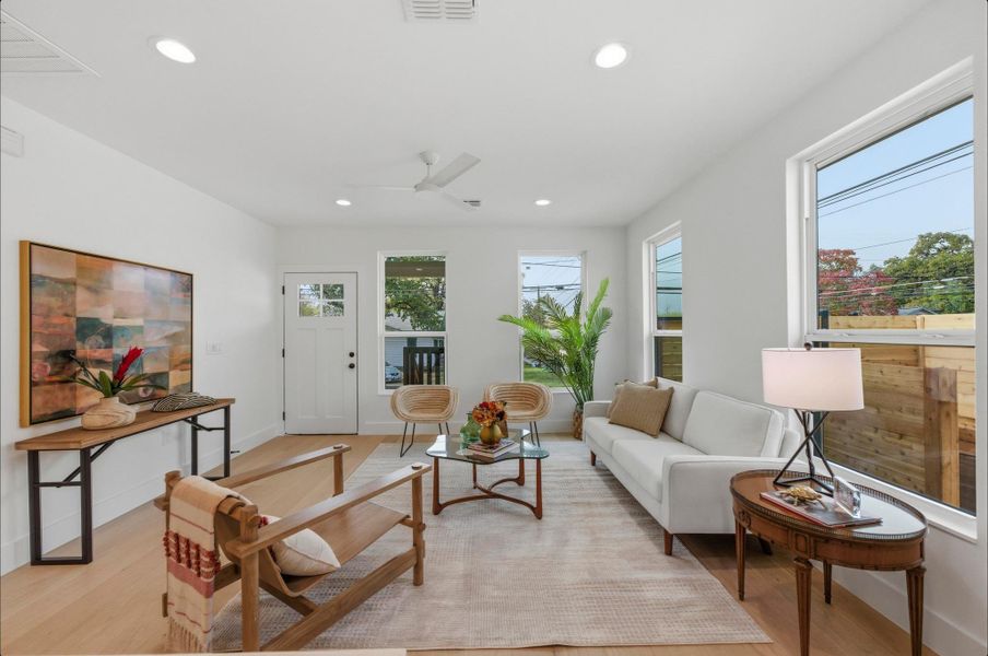 Living area featuring ceiling fan, recessed lighting, and light wood-style floors