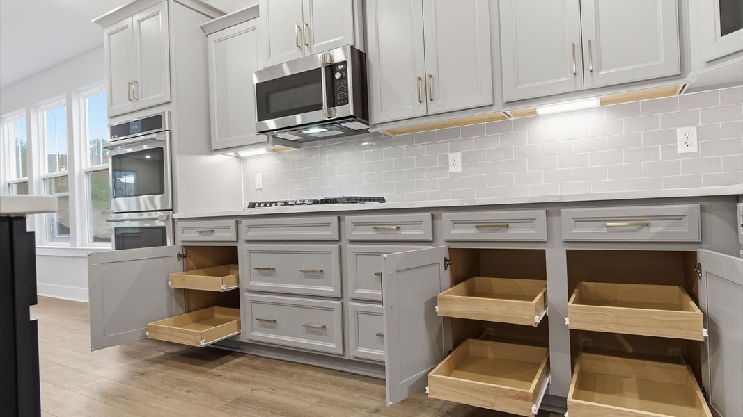 Tasteful kitchen with sleek cabinetry—crafted to high standards at the Woodglen community Tasteful kitchen with sleek cabinetry—crafted to high standards at the Woodglen community