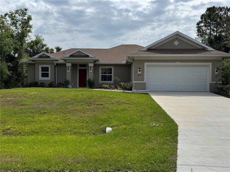 Front exterior of a new home in , North Port, FL, highlighting curb appeal (Image 1). Front exterior of a new home in , North Port, FL, highlighting curb appeal (Image 1).
