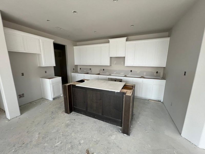 Kitchen with white cabinetry and a center island