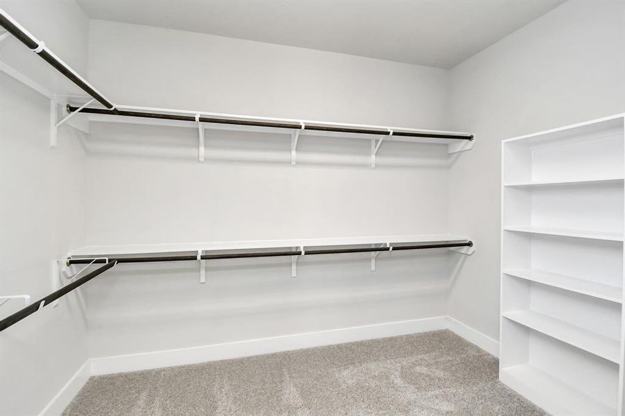 Walk-in closet that epitomizes luxury and practicality. This generously sizedspace features built-in shelving, offering abundant room for impeccableorganization. High ceilings and recessed lighting create a bright andwelcoming ambiance.