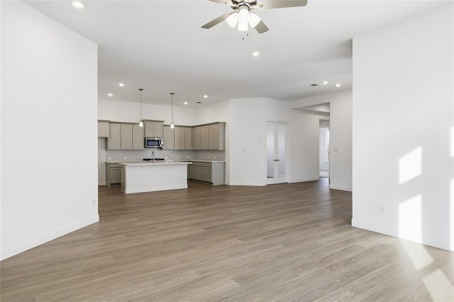 Unfurnished living room featuring recessed lighting, light wood-style floors, and a ceiling fan