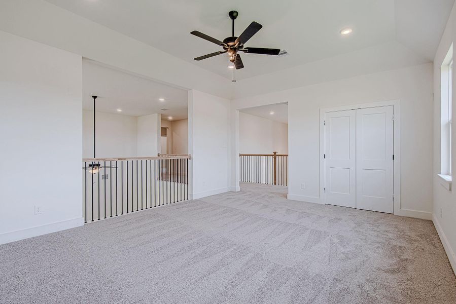 Another generously sized bedroom with plush carpet and a versatile layout