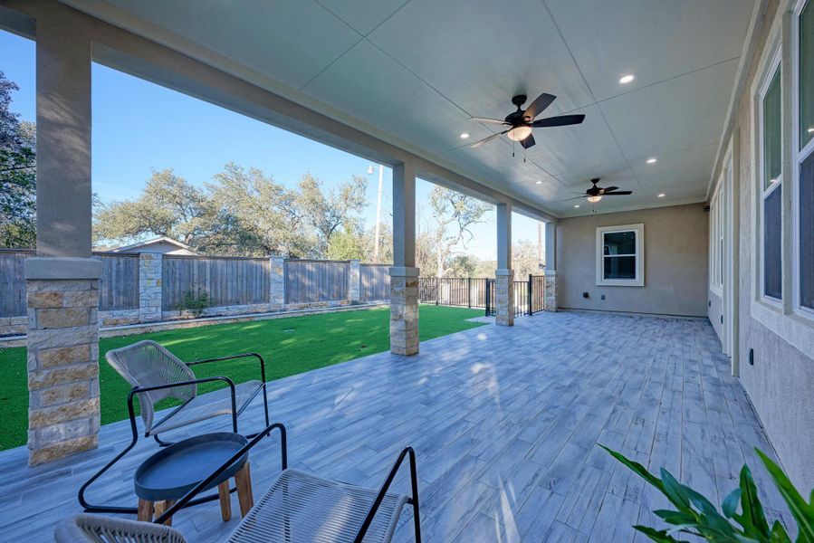 Wooden terrace featuring a patio, ceiling fan, and a fenced backyard