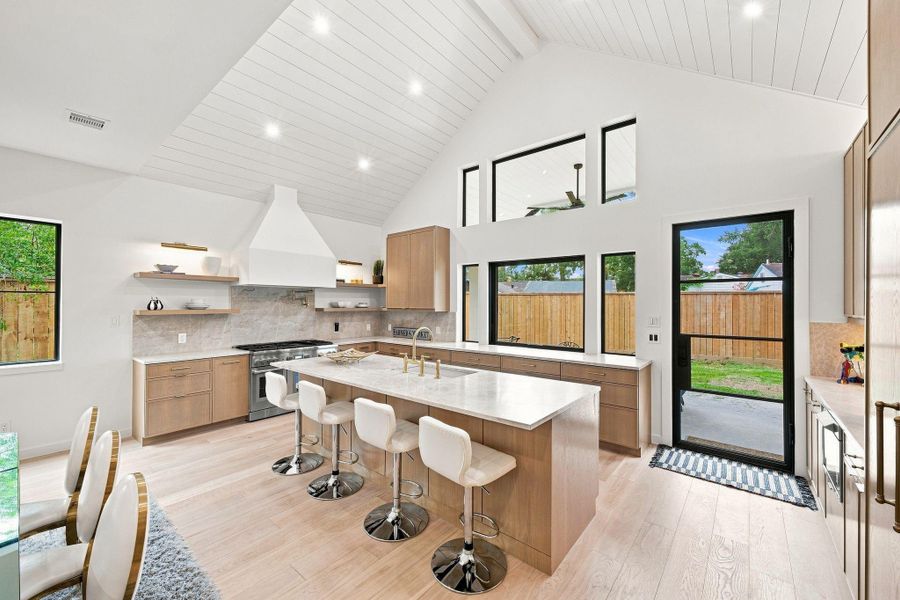Kitchen with custom cabinets, Taj Mahal countertops, and Thermadore appliances.