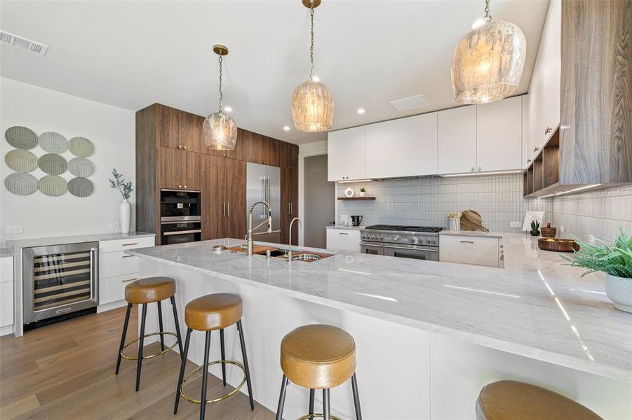 Whether hosting a casual gathering or a formal affair, this kitchen's spacious layout and top-notch features make it the ideal setting for culinary excellence and socializing.