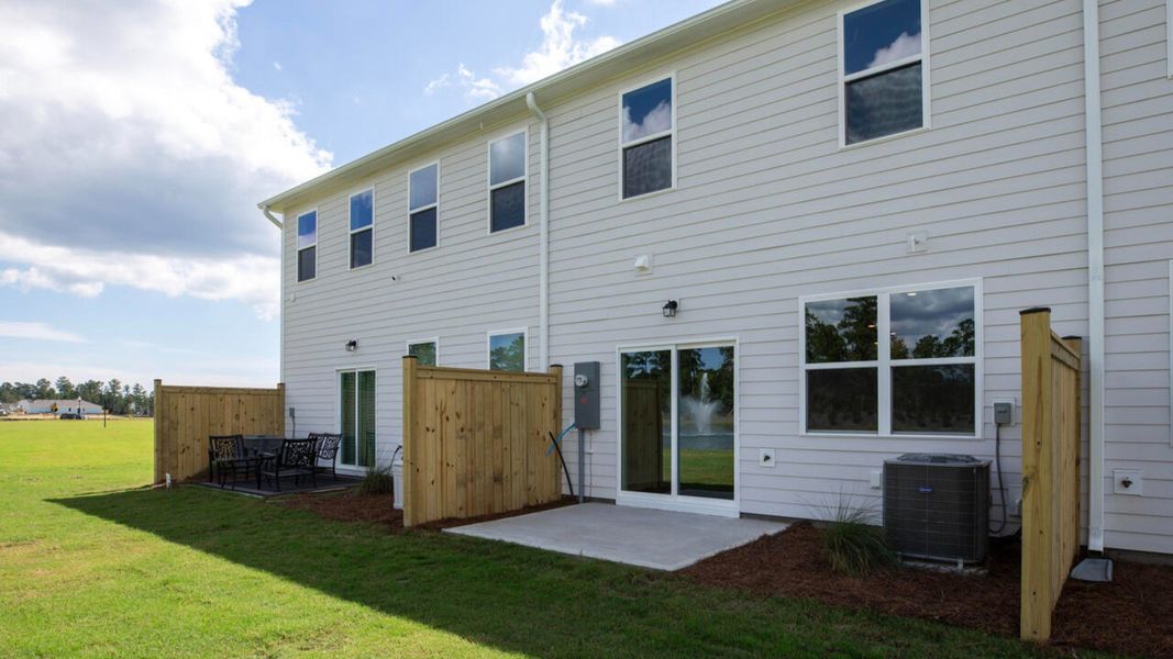 Exterior details and patio area of a home in Indigo Preserve Townhomes, Leland (Image 3).