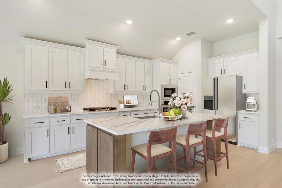Kitchen with white cabinets, marble island with seating, tile backsplash, and stainless steel appliances Kitchen with white cabinets, marble island with seating, tile backsplash, and stainless steel appliances
