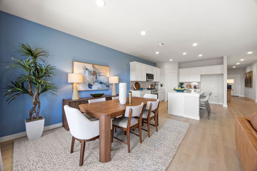 A dining room with a table and chairs. A dining room with a table and chairs.