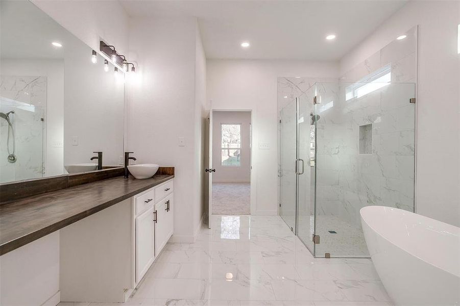 Bathroom featuring plus walk in shower and vanity