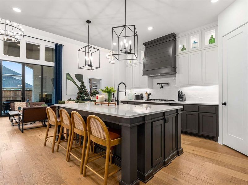 The HUGE island features a breakfast bar and beautiful lighting