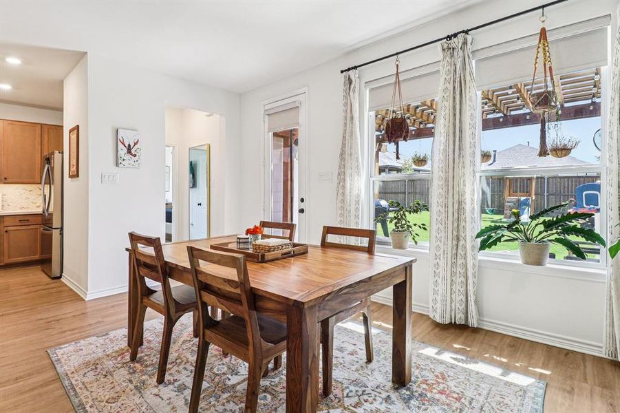 Dining space with light wood finished floors and recessed lighting Dining space with light wood finished floors and recessed lighting