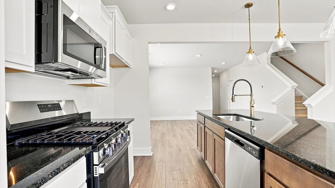 Exceptional culinary space with a striking 9-foot island and eye-catching pendant lights Exceptional culinary space with a striking 9-foot island and eye-catching pendant lights