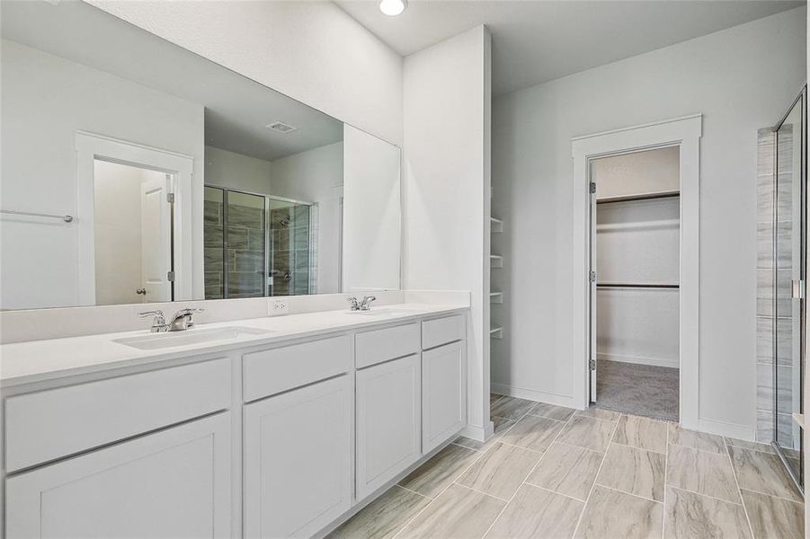 Bathroom featuring tile patterned floors, an enclosed shower, and vanity