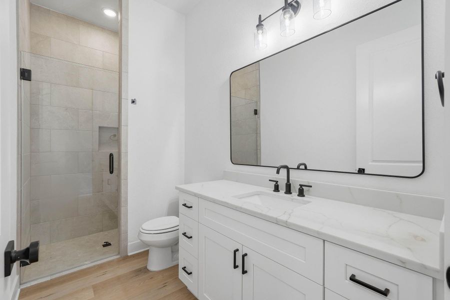 Secondary bath with high end finishes and walk in shower.