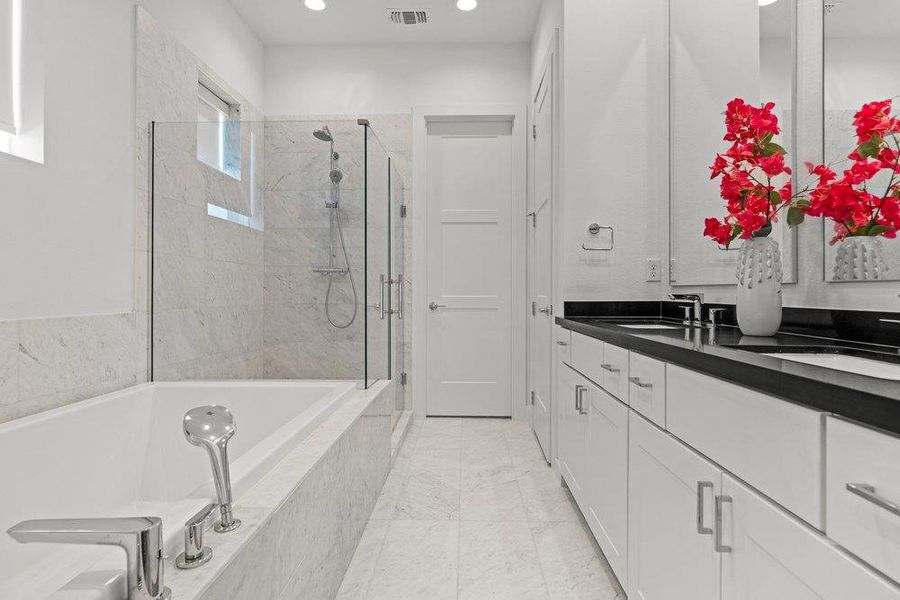 Luxurious white marble flooring and walls elevate this sleek bathroom. Luxurious white marble flooring and walls elevate this sleek bathroom.