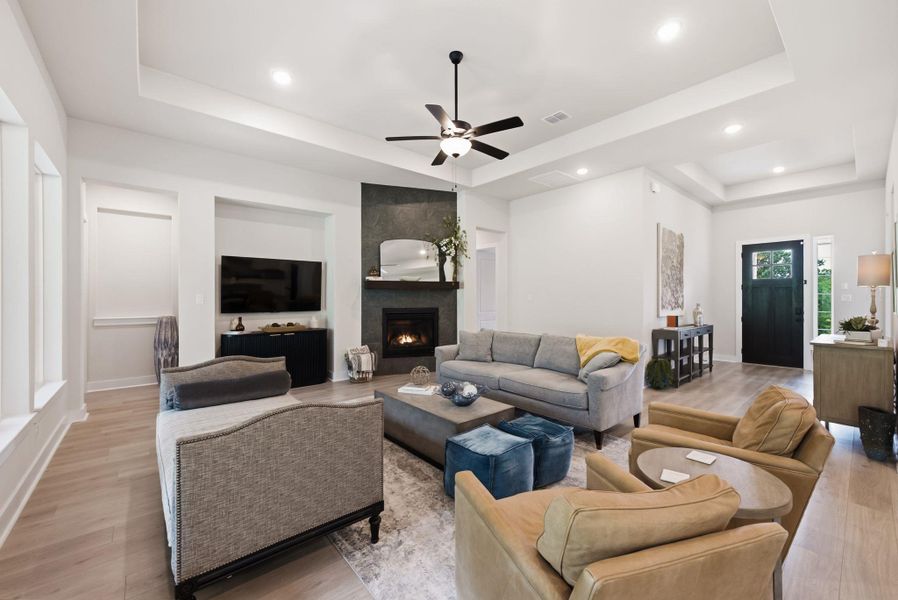 A cozy fireplace serves as the heart of this comfortable gathering space, making it easy to unwind with family or host friends on a cool Texas evening