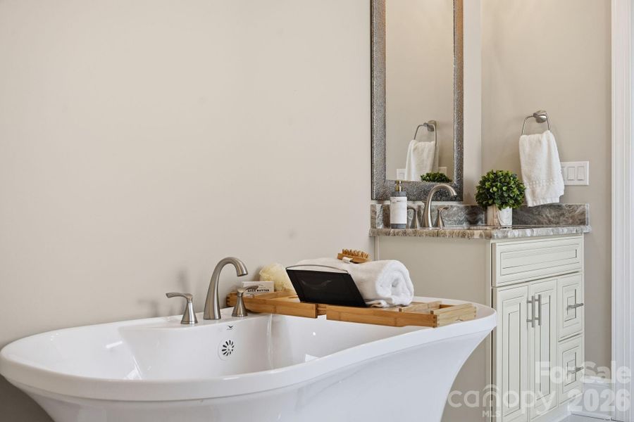 Primary suite freestanding soaking tub — spa-inspired luxury in your own home. Primary suite freestanding soaking tub — spa-inspired luxury in your own home.