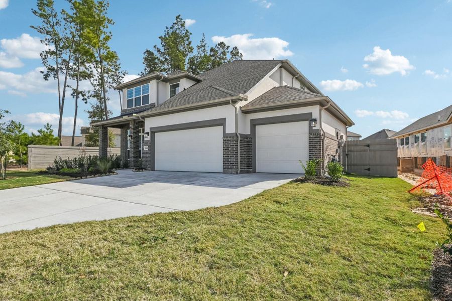 Front exterior of a new home in Artavia, Conroe, TX, highlighting curb appeal (Image 2). Front exterior of a new home in Artavia, Conroe, TX, highlighting curb appeal (Image 2).