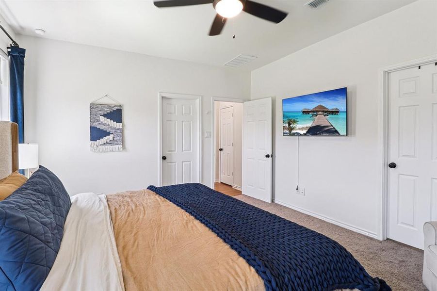 Carpeted bedroom with baseboards and ceiling fan Carpeted bedroom with baseboards and ceiling fan