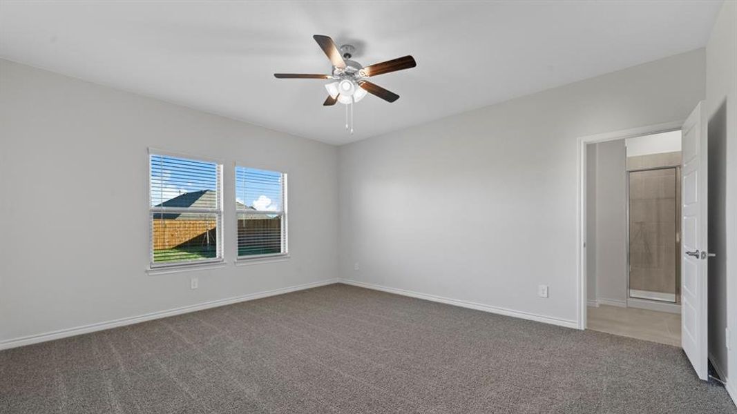 Unfurnished room featuring carpet flooring and a ceiling fan Unfurnished room featuring carpet flooring and a ceiling fan