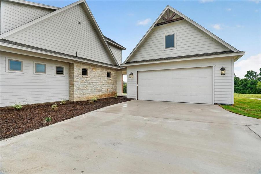 Front exterior of a new home in , Poolville, TX, highlighting curb appeal (Image 19).