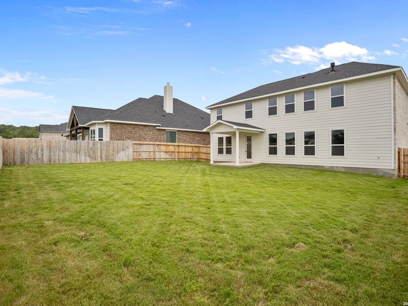 Exterior details and patio area of a home in The Reserve at Potranco Oaks, Castroville (Image 27).