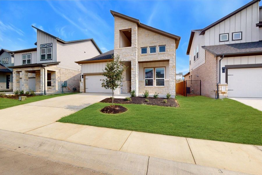 Front exterior of a new home in Estancia West, Manchaca, TX, highlighting curb appeal (Image 18). Front exterior of a new home in Estancia West, Manchaca, TX, highlighting curb appeal (Image 18).