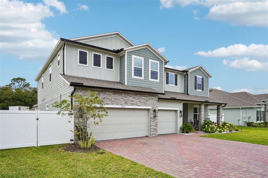 Front exterior of a new home in Elegant Manor Estates, Edgewater, FL, highlighting curb appeal (Image 2). Front exterior of a new home in Elegant Manor Estates, Edgewater, FL, highlighting curb appeal (Image 2).