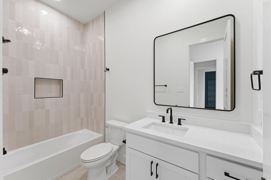 Full bathroom with access to bedroom.