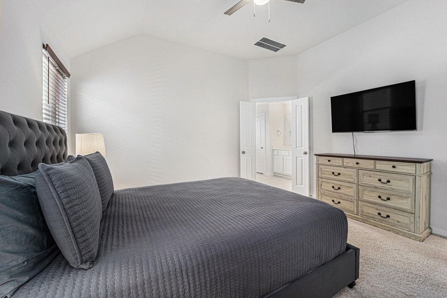 Primary suite with ensuite bath access and room for a full furniture set.
