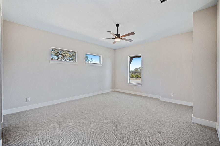 Spare room featuring carpet flooring, baseboards, visible vents, and a ceiling fan Spare room featuring carpet flooring, baseboards, visible vents, and a ceiling fan