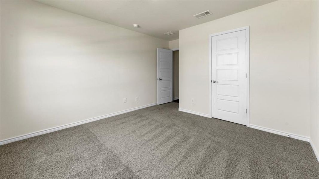 This room features light-colored walls, gray carpeting, and white trim