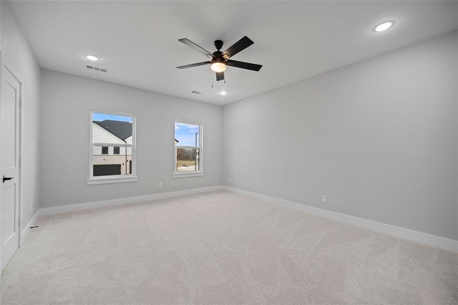 Unfurnished room with recessed lighting, baseboards, and light colored carpet