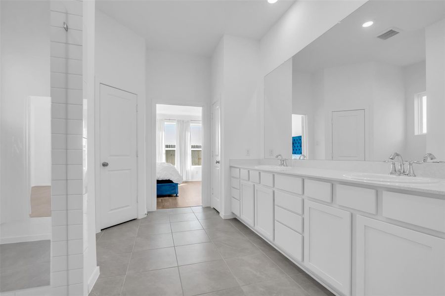 Primary Bathroom: Oversized layout with extended dual vanity, generous storage, and a clean, spa-like feel. Thoughtfully positioned with a direct view into the primary suite, reinforcing the scale and private retreat design. Primary Bathroom: Oversized layout with extended dual vanity, generous storage, and a clean, spa-like feel. Thoughtfully positioned with a direct view into the primary suite, reinforcing the scale and private retreat design.