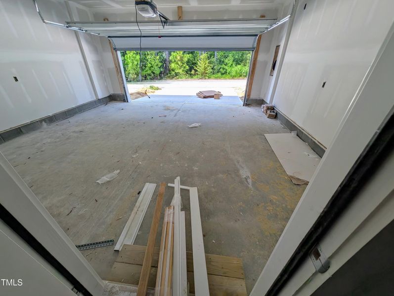 2 Car back loading garage with a tree vi