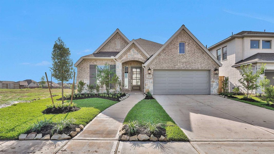 Front exterior of a new home in Sienna 50', Missouri City, TX, highlighting curb appeal (Image 2). Front exterior of a new home in Sienna 50', Missouri City, TX, highlighting curb appeal (Image 2).