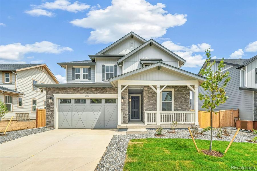 Front exterior of a new home in Windsong, Thornton, CO, highlighting curb appeal (Image 1).