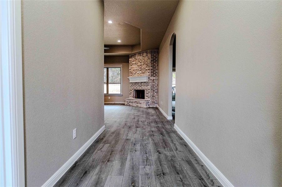 Corridor with dark hardwood / wood-style floors