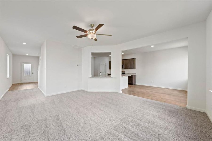 Living room with ceiling fan and carpet