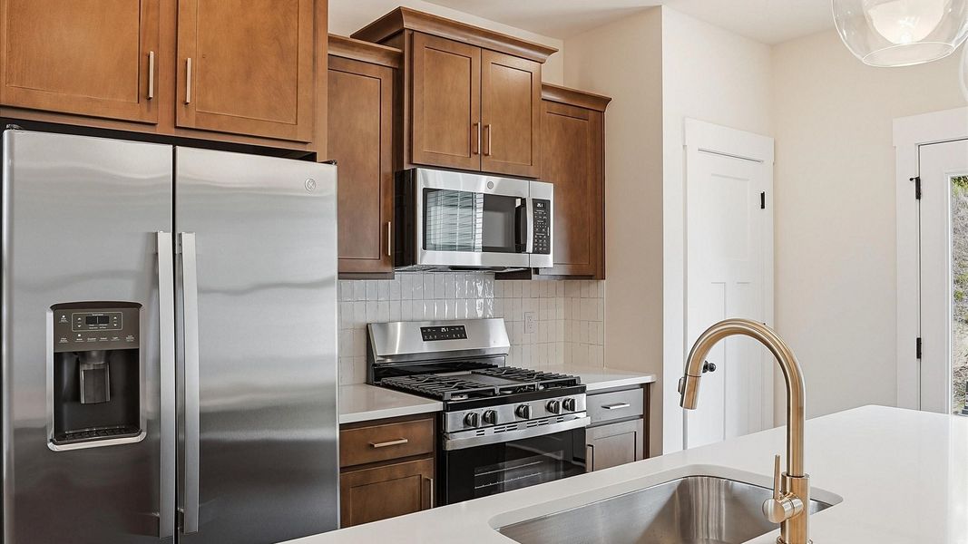 Well-designed kitchen with a center island and tasteful finishes that elevate everyday living located at Marion Square Well-designed kitchen with a center island and tasteful finishes that elevate everyday living located at Marion Square