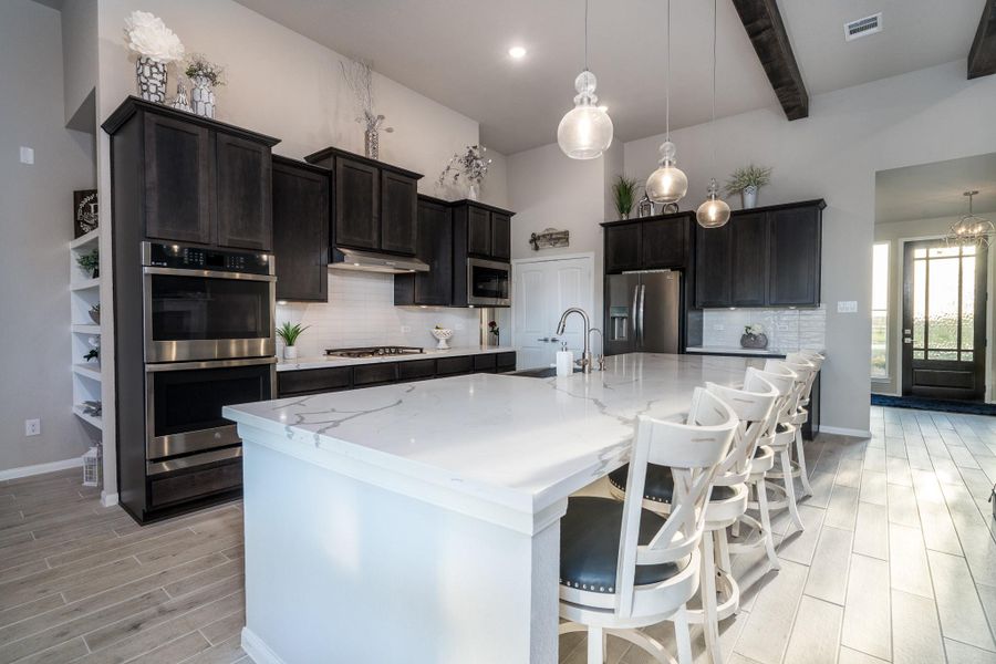 Astonishing 12 foot island with gleaming designer quartz countertops...an entertainers dream island!