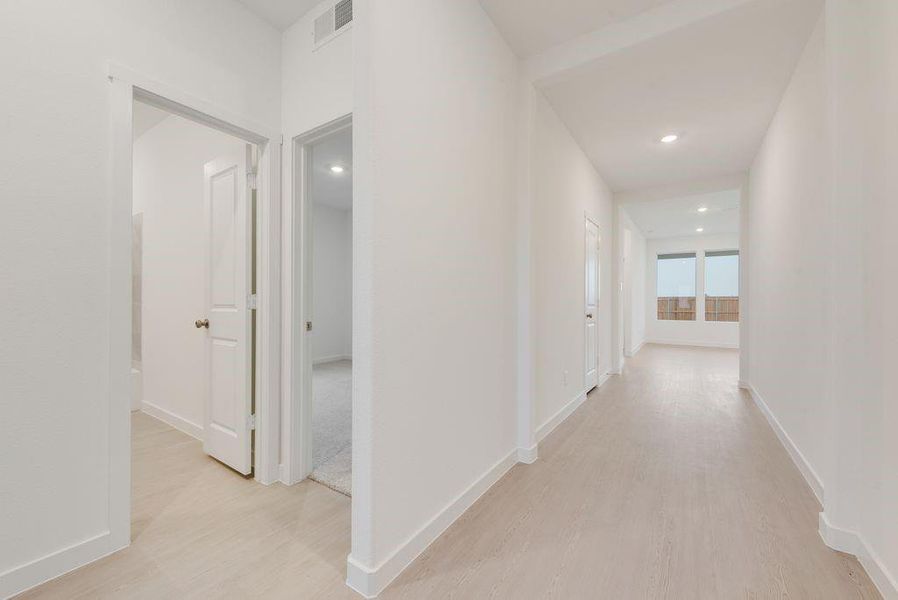 Hall featuring light wood finished floors and recessed lighting Hall featuring light wood finished floors and recessed lighting