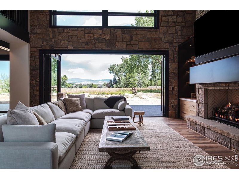 Indoor/outdoor experience with oversized accordion doors in the great room. Oversized Isokern, open hearth fireplace