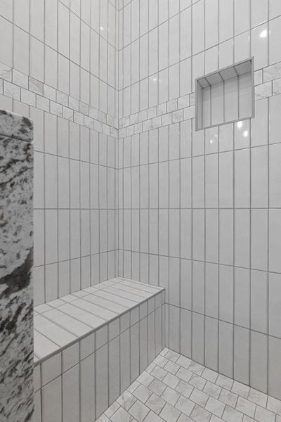 Full bath with a tile shower and a sauna / steam room