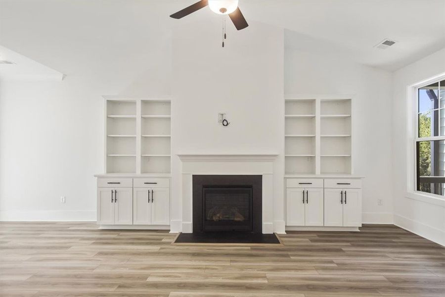 Custom built-in shelving and a classic fireplace a